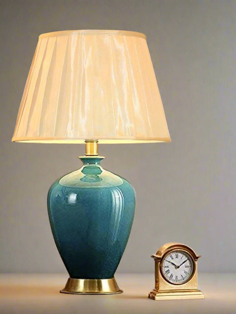 Tatva Lights Timeless Navy Blue Ceramic Table Lamp featuring a glossy navy blue ceramic base with gold accents and a pleated beige lampshade—an elegant and versatile lighting piece for sophisticated bedside or living room decor.