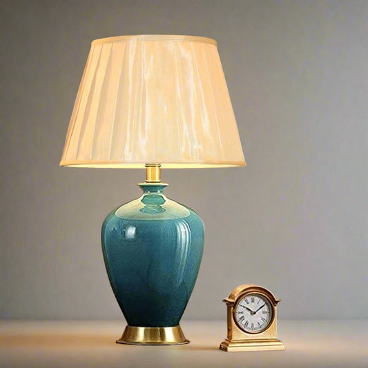 Tatva Lights Timeless Navy Blue Ceramic Table Lamp featuring a glossy navy blue ceramic base with gold accents and a pleated beige lampshade—an elegant and versatile lighting piece for sophisticated bedside or living room decor.